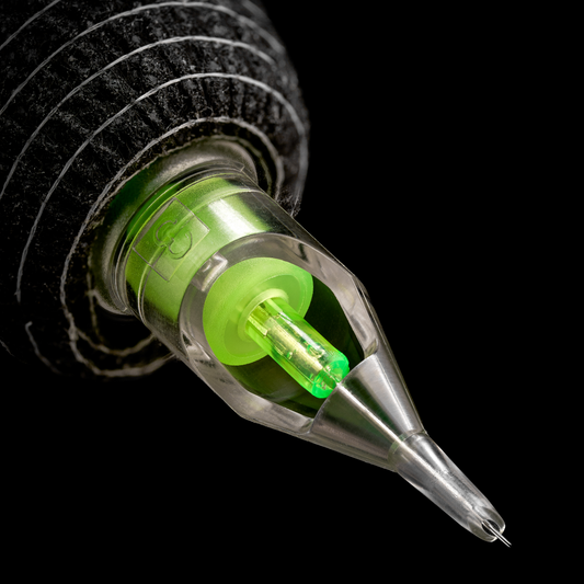 Macro close-up of a tattoo machine tip with a clear cartridge and neon green internal components.