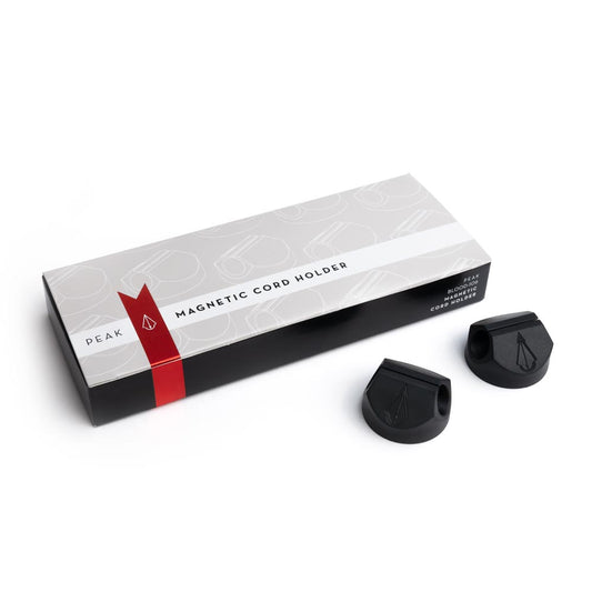 Box of Magnetic Cord Holders with two holders out of box on white background, thumbnail size