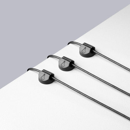 Example of three cord holders on workstation surface holding wires